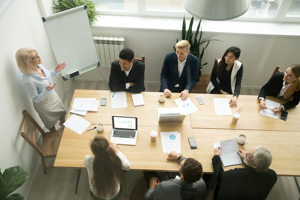 Group of workers around a large conference table.